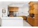 Modern kitchen with light wood cabinets, white countertops, and stainless steel appliances at 1060 Water Oak Ne Ct, St Petersburg, FL 33703