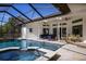 Relaxing pool and spa area with covered patio and seating at 1060 Water Oak Ne Ct, St Petersburg, FL 33703