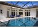 Inviting pool and spa with covered patio and outdoor seating at 1060 Water Oak Ne Ct, St Petersburg, FL 33703