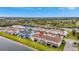 Aerial view of townhome community near a lake, showing the property's waterfront location at 11630 Woodleaf Dr, Bradenton, FL 34211