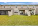 Manicured backyard featuring lush lawn, a covered patio, and privacy fence at 11630 Woodleaf Dr, Bradenton, FL 34211