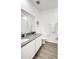 Modern bathroom with grey countertops and wood-look tile floor at 11630 Woodleaf Dr, Bradenton, FL 34211