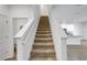 Carpeted staircase with view of kitchen at 11630 Woodleaf Dr, Bradenton, FL 34211