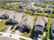 Aerial view of a well-maintained home with a neatly kept yard in a quiet suburban neighborhood at 11794 Little River Way, Parrish, FL 34219