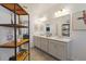 Bright bathroom featuring a double vanity with white countertops, modern lighting, and stylish decorative accents at 11794 Little River Way, Parrish, FL 34219