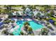 Aerial view of a community pool featuring a zero entry point, palm trees, and ample seating at 11794 Little River Way, Parrish, FL 34219