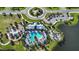 Aerial view of the community pool featuring ample seating, palm trees, and a playground at 11794 Little River Way, Parrish, FL 34219