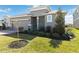 Beautiful home exterior featuring a well-kept lawn and decorative landscaping at 11794 Little River Way, Parrish, FL 34219