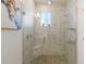 Stunning main bathroom with a glass enclosed walk-in shower and marble tile surround at 11794 Little River Way, Parrish, FL 34219