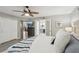 Bright main bedroom with king bed, built-in TV, and ensuite bathroom at 120 Tidy Island Blvd # 120, Bradenton, FL 34210