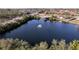 Expansive aerial view showcasing the community's lake with fountain, pool, and surrounding amenities at 1210 56Th W St # 1210, Bradenton, FL 34209