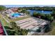 Community shuffleboard courts offering a fun recreational activity with the pool and lake in the background at 1210 56Th W St # 1210, Bradenton, FL 34209