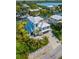 Aerial view of a waterfront home with a two-car garage and lush landscaping at 130 Burns Rd, Terra Ceia, FL 34250