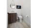 Modern powder room with sleek dark wood vanity at 130 Burns Rd, Terra Ceia, FL 34250