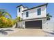 Modern two-story home with a dark gray garage door and white exterior at 130 Burns Rd, Terra Ceia, FL 34250