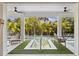 Inviting pool area with a rectangular pool, a wooden bench, and lush tropical foliage providing shade at 130 Burns Rd, Terra Ceia, FL 34250