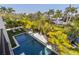 Inviting pool area surrounded by tropical landscaping at 130 Burns Rd, Terra Ceia, FL 34250