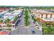 Aerial view of a vibrant downtown area with shops and palm trees at 1364 Berkshire Ct, Venice, FL 34292