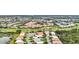 Aerial view of a community near a golf course, offering various house styles at 1364 Berkshire Ct, Venice, FL 34292