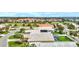 Aerial view showcasing a house with a pool and solar panels in a tranquil community at 1364 Berkshire Ct, Venice, FL 34292