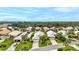 Aerial view of a luxury community with houses, lush landscaping, and a golf course at 1364 Berkshire Ct, Venice, FL 34292