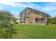 Landscaped backyard showcasing a pool and screened enclosure at 1364 Berkshire Ct, Venice, FL 34292