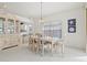 Elegant dining room with oval table, six chairs, and a china cabinet at 1364 Berkshire Ct, Venice, FL 34292