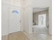 Bright entryway with tiled floor, white door and view to living room at 1364 Berkshire Ct, Venice, FL 34292