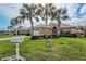 Exterior view of tan house with white mailbox and palm trees at 1364 Berkshire Ct, Venice, FL 34292