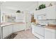 Galley style kitchen with white cabinets, and stainless steel appliances at 1364 Berkshire Ct, Venice, FL 34292