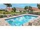 Community pool with surrounding lounge chairs at 1364 Berkshire Ct, Venice, FL 34292