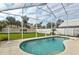 Inviting kidney-shaped pool with screened enclosure at 1364 Berkshire Ct, Venice, FL 34292