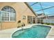 Lovely kidney-shaped pool with screened enclosure at 1364 Berkshire Ct, Venice, FL 34292