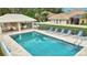 Community pool with lounge chairs and covered patio at 1364 Berkshire Ct, Venice, FL 34292