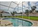 Relaxing kidney-shaped pool with screened enclosure at 1364 Berkshire Ct, Venice, FL 34292