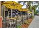 Outdoor patio with yellow umbrellas and tables for dining at 1364 Berkshire Ct, Venice, FL 34292