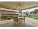 Screened patio with seating area, adjacent to pool at 1364 Berkshire Ct, Venice, FL 34292