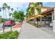 Outdoor seating at a restaurant with palm trees and parked cars at 1364 Berkshire Ct, Venice, FL 34292