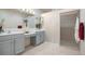 Double vanity bathroom with walk-in shower at 1410 Maseno Dr, Venice, FL 34292