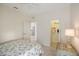 Well-lit bedroom with floral bedding and a spacious closet at 1410 Maseno Dr, Venice, FL 34292