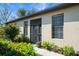 House exterior featuring a screened entryway and lush landscaping at 1410 Maseno Dr, Venice, FL 34292