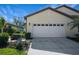 Two-story house with attached garage and landscaping at 1410 Maseno Dr, Venice, FL 34292