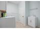 Bright laundry room with washer, dryer, and utility sink at 1410 Maseno Dr, Venice, FL 34292