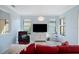 Living room with red sectional sofa and white media cabinet at 1410 Maseno Dr, Venice, FL 34292