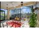 Relaxing screened porch with wooden bench and potted plants at 1410 Maseno Dr, Venice, FL 34292