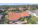 Aerial view of the home shows tile roof, lawn, landscaping and screened-in pool at 1426 Landview Ln, Osprey, FL 34229