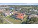 Aerial view of home shows the screened-in pool, lawn, and landscaping at 1426 Landview Ln, Osprey, FL 34229