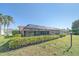 Wide shot of the backyard with a screened-in pool, lawn, and partial view of the home at 1426 Landview Ln, Osprey, FL 34229