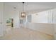 Open-concept dining room with tile floors, contemporary lighting, and easy access to the kitchen and entryway at 1426 Landview Ln, Osprey, FL 34229