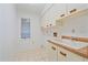 Laundry room featuring white cabinetry, sink, and window at 1426 Landview Ln, Osprey, FL 34229